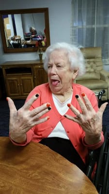Resident showing off colorful nail polish in a common area