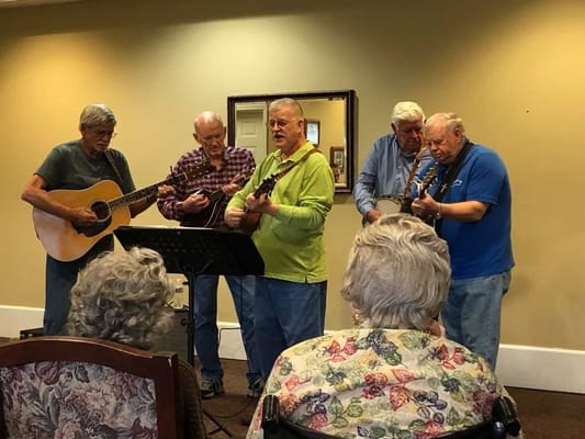 Residents enjoying a musical performance in a common area