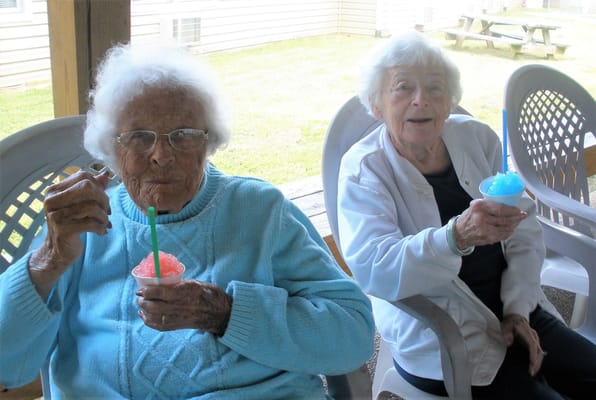 Residents enjoying shaved ice on a patio