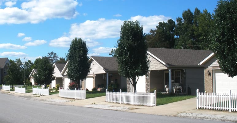 Row of retirement community cottages with green lawns