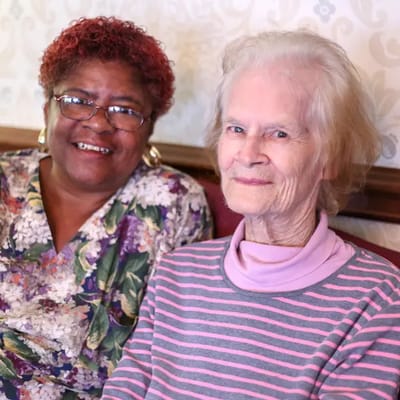 Residents smiling together in a cozy common area