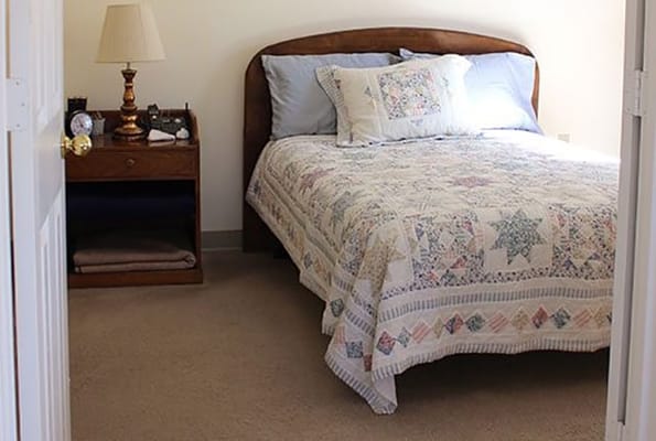 Cozy bedroom with a quilted bedspread and nightstand