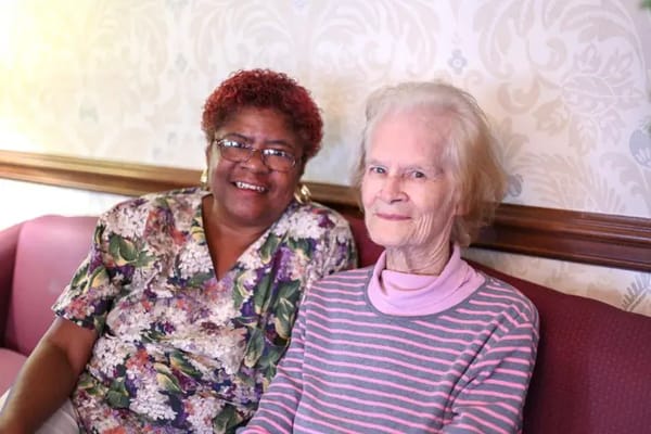 Two residents enjoying time together in a common area
