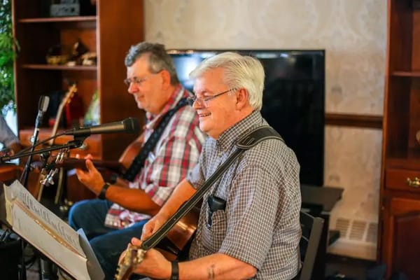 Residents enjoying a live music event in a common area