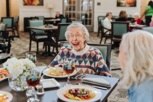 Resident enjoying a meal in the dining room