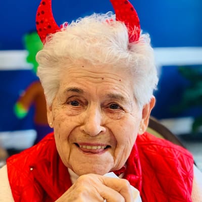 Senior resident happily dressed for a celebration