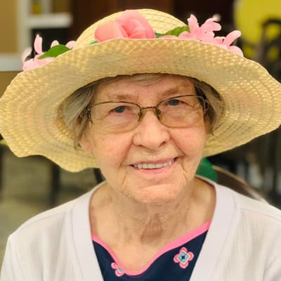Resident wearing a straw hat with flowers