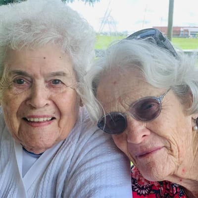 Two smiling residents enjoying time together