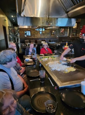 Residents enjoying a meal preparation activity at the dining area