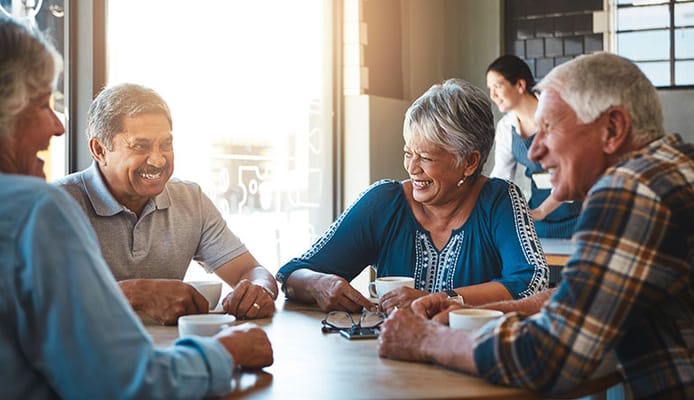 Residents enjoying coffee and conversation in a common area