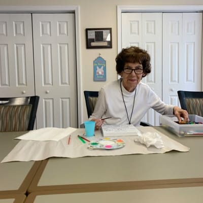Resident participating in an art activity in a common area