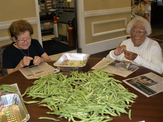 Residents engaging in an activity at a dining table