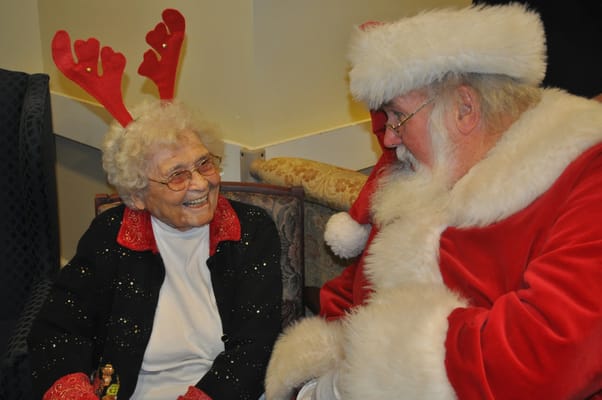 Resident with Santa Claus during holiday celebrations