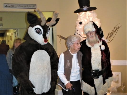 Residents celebrating with Santa and a reindeer costume
