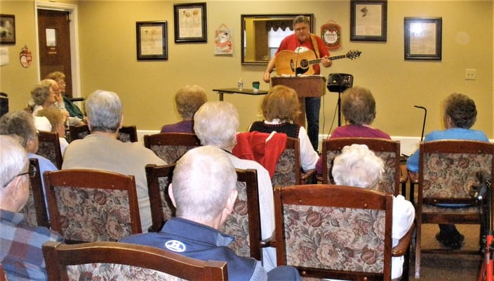 Residents enjoying a musical performance in a common area