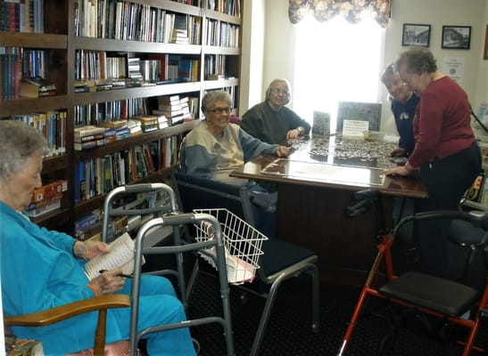 Residents engaging in a puzzle activity in a common space