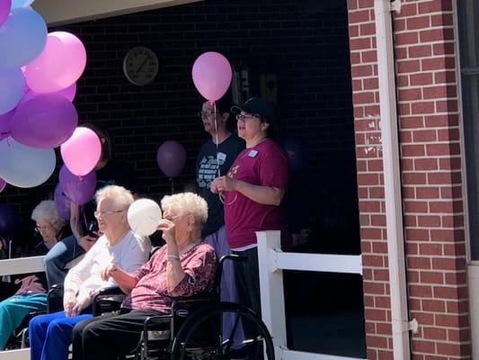 Residents and staff celebrating with balloons