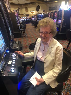 Senior woman enjoying a gaming machine in an activity area