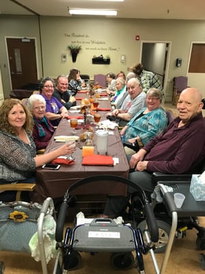 Residents enjoying a meal together in the dining room