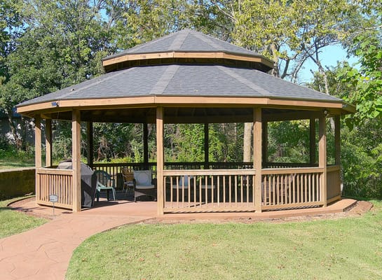 Wooden gazebo in a green outdoor setting