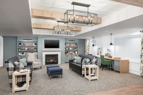 Cozy interior common area with seating and bookshelves