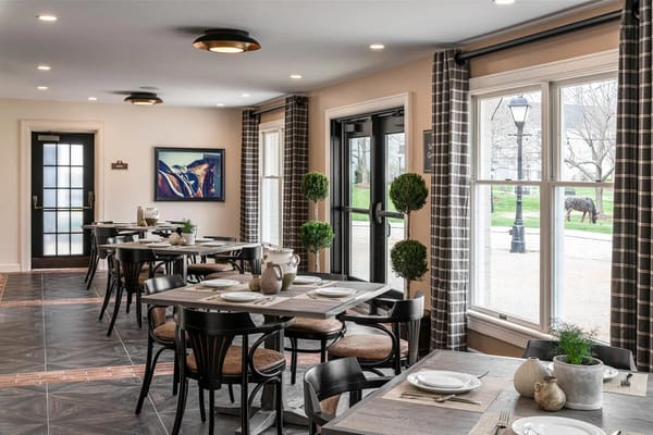 Bright dining area with tables and views to outdoor space