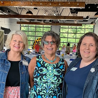 Staff members posing at a celebratory event in the facility