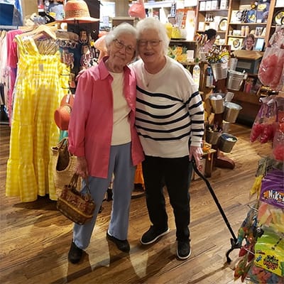 Two residents smiling in a vibrant shop environment