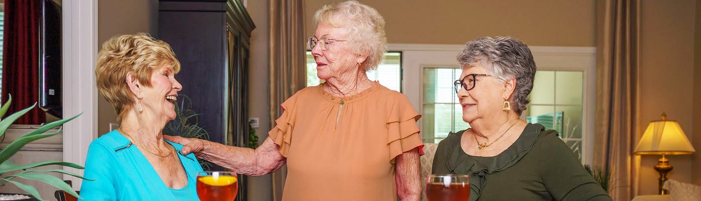 Residents enjoying drinks and conversation in a common area
