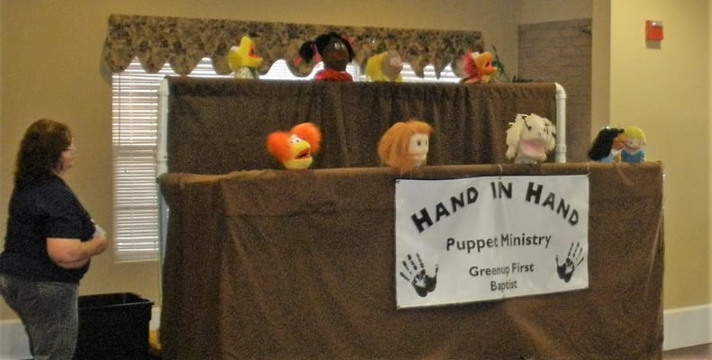 Puppet show performance in a community room