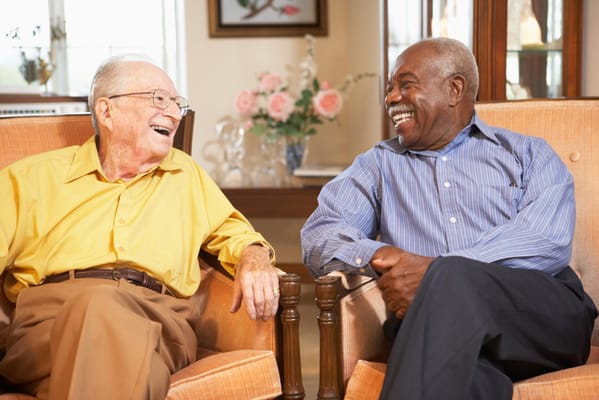 Two residents enjoying a conversation in a lounge area