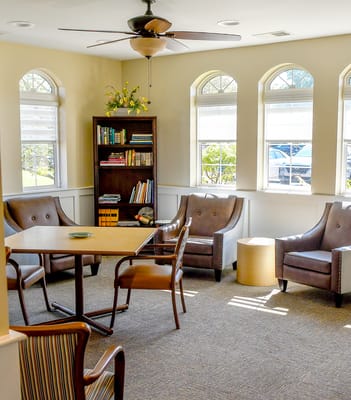 Bright common area with comfortable seating and bookshelves