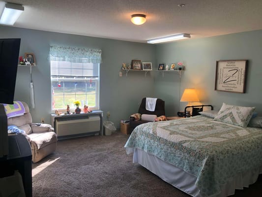 Cozy resident room with a bed and seating area