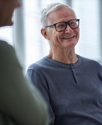 Smiling senior resident engaging in conversation
