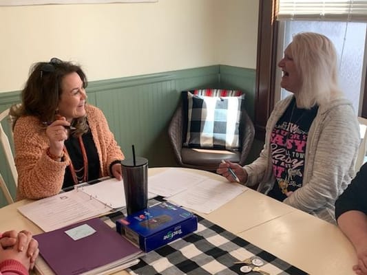 Two women engaged in conversation at a table