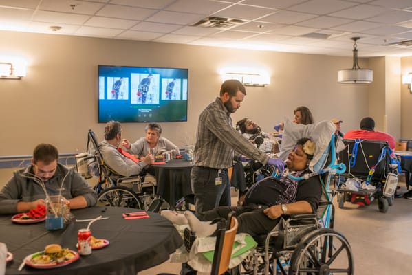 Residents interacting with staff in a communal space