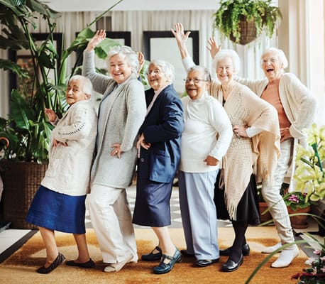 Residents posing joyfully in a common area
