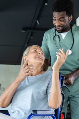 Healthcare worker engaging with a resident in a wheelchair