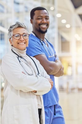 Two healthcare professionals smiling in a facility