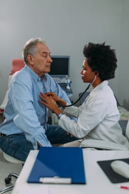 Healthcare professional examining a senior resident
