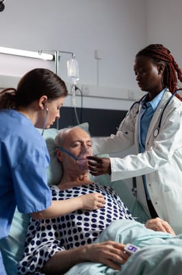 Medical staff attending to a senior patient in a hospital room
