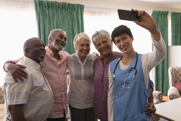Residents and staff taking a selfie together in a common area