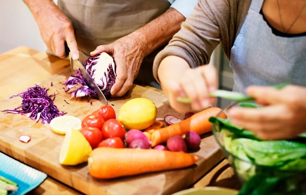 Residents preparing fresh vegetables in a kitchen