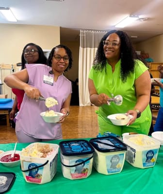Staff serving ice cream to residents in a common area