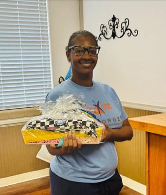 Staff member holding a gift basket in a common area