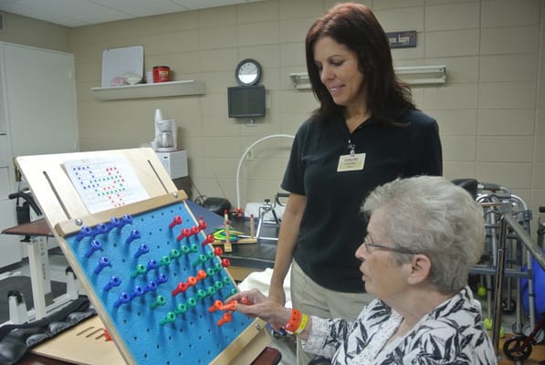 Therapist assisting a resident with an activity