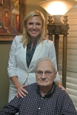 A staff member with a resident in a well-lit room