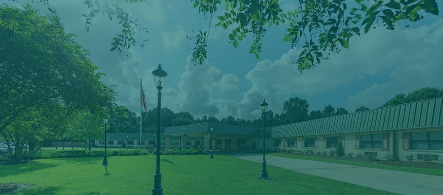 Exterior view of Baton Rouge Health Care Center surrounded by greenery