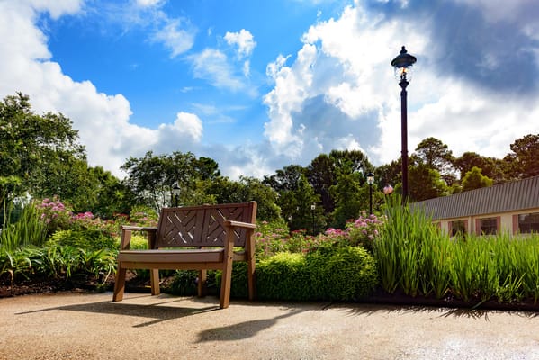 Outdoor seating area with flowers and greenery