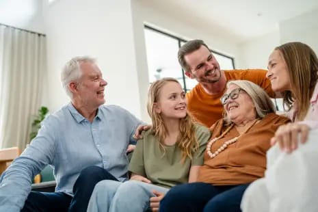 Family gathering with residents in a cozy living area